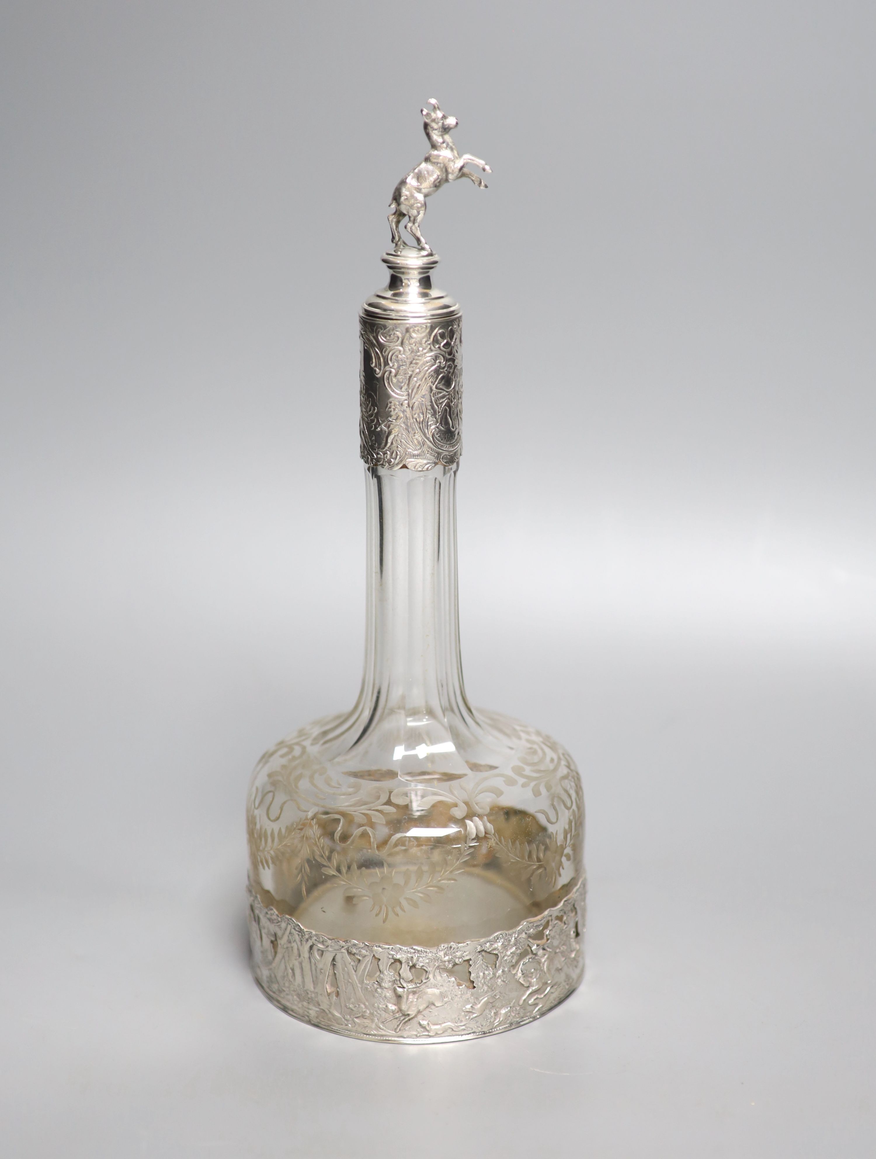 A late 19th/early 20th century Hanau? white metal mounted glass decanter, with rearing horse mounted stopper, 31.5cm